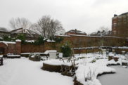 A walled garden covered in snow.