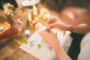 Child's hands gluing gems on craft activity
