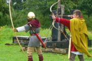 Two men dressed as Romans taking part in archery