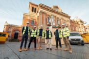 Five men in hard hats and hi viz vests stood in front of Kidderminster Town Hall, an historic listed building