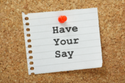 Note saying have your say pinned to a cork notice board