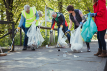 Group of people litter picking a pavement