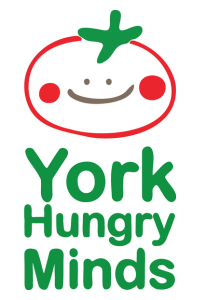 The logo for York Hungry Minds with a smiling tomato 