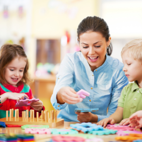 A woman reads to young children