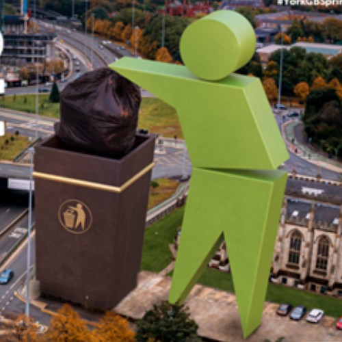 A giant stick figure puts rubbish into a bin