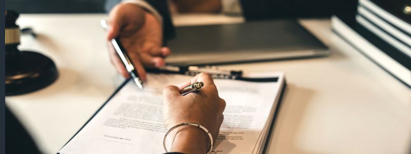 Two people sign a business contract
