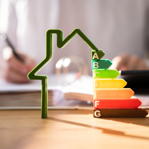 Someone writes on a notebook in the background behind an energy efficiency logo