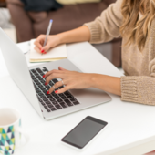 A woman sits at a laptop working