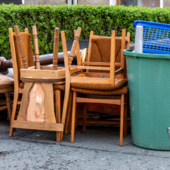 A stack of wooden chairs waiting for collection