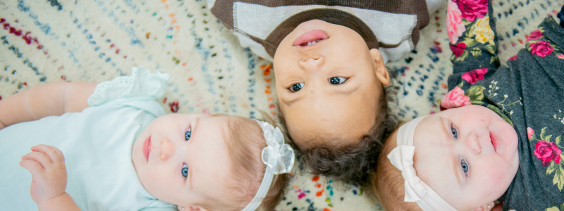 Group of babies lying on a mat