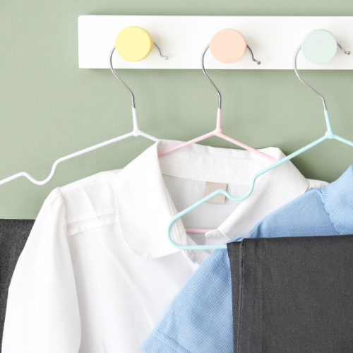 Image of shirts and trousers on hangers