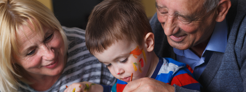 Grandparents painting with grandchild