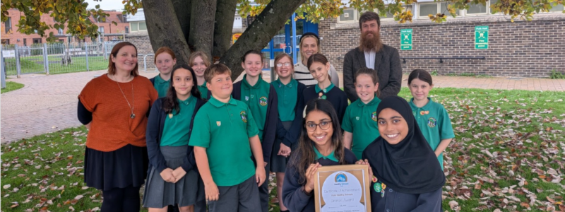 Pupils and staff from Yearsley Grove Primary are pictured receiving a Bronze Award for their work on the Active Lives theme.