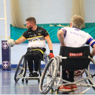 Two men playing wheelchair basketball