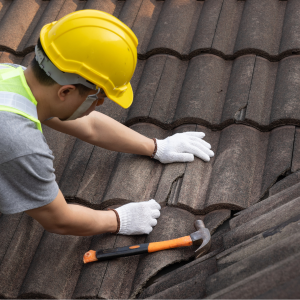 A man repairs a leaking roof