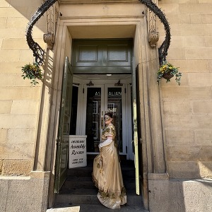 A woman in Georgian costume on the steps of York Assembly Rooms