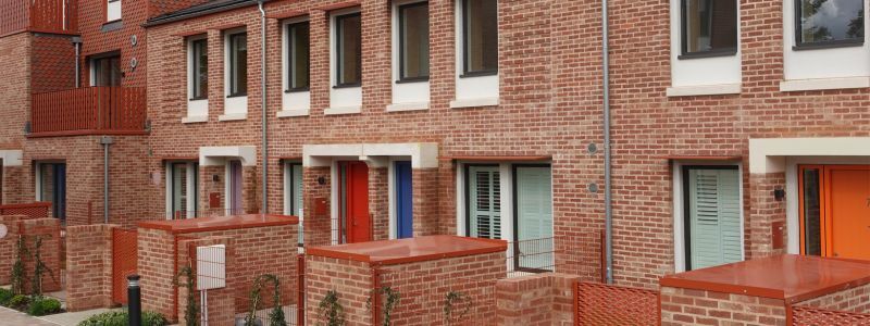 A row of terraced homes and front gardens
