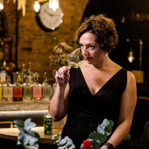A woman drinking from a glass of wine