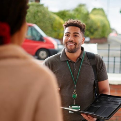 A smiling person at a front door