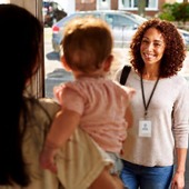 Woman visits a mother and child at home