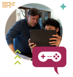 A child and parent look at a tablet together.