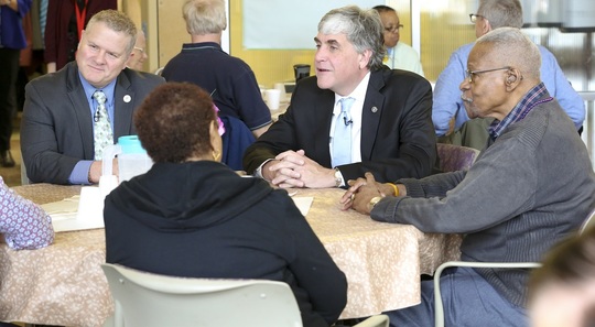 Hargan and Robertson at table with older adults