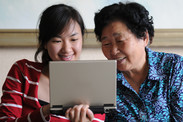 Grandmother and daughter at computer