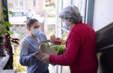 Woman home-delivering meals to older adults