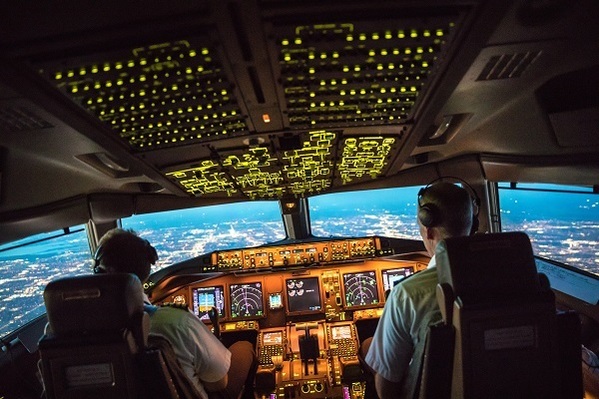 pilots in cockpit of commercial aircraft