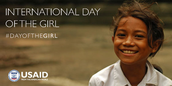 International Day of the Girl. A young girl smiles at the camera.