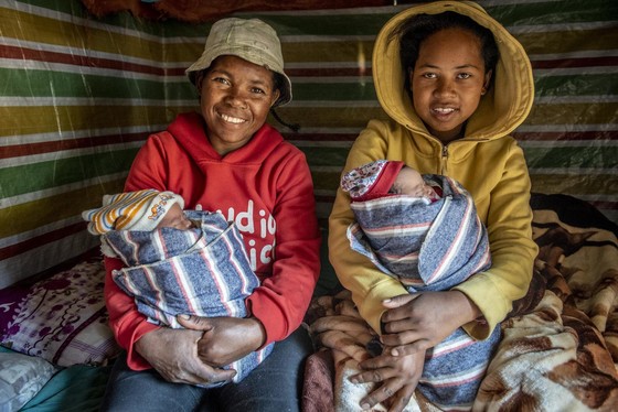 Anjomkely, Madagascar, mother Harimasy Rasolofolala poses with daughter Marya Ranjanirina and her newborn twins 