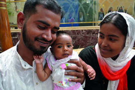 Baby Tayeeba with her smiling parents in Bangladesh.