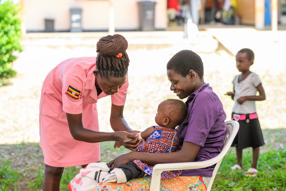 Health worker measuring child nutrition status