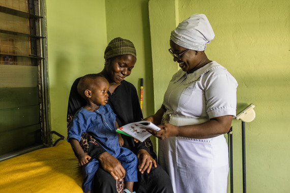 A health worker talking to a mother 