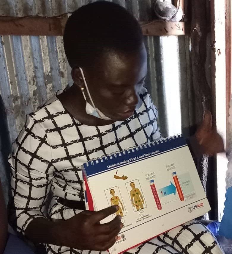 A nurse uses visuals to explain the role of antiretroviral therapy to HIV-positive persons. Photo: IntraHealth