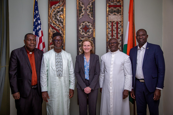 Deputy Administrator Coleman stands with four faith leaders