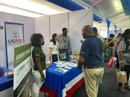 At the 2022 Regional Agricultural Expo in Trinidad, Guyana EDA awardees talk with visitors to their booth, showing all awardees' products.