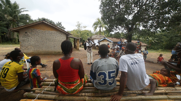 John, a Community Health Assistant in Liberia, gives a health talk to his community on malaria prevention.