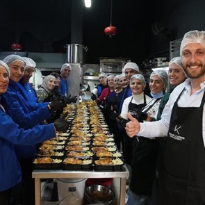 Cooperative members from across Lebanon smile at the camera next to the food they prepared for community members during the holiday season