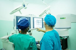 CURE Zambia staff using the C-Arm.