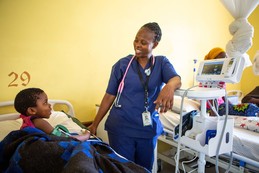 CURE Zambia staff using a vital signs monitor. 