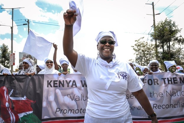 Fanis Lisiagali, Executive Director of Healthcare Assistance Kenya, leads the White Ribbon Campaign march 