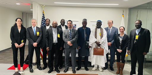 Adam Phillips and Karl Fickenscher take photo with delegation of faith leaders from the Sahel Peace Initiative 