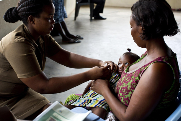 A nurse vaccinates a baby