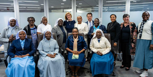 Women in Faith Leadership Cohort pose for group photo with Administrator Power and Director Phillips 
