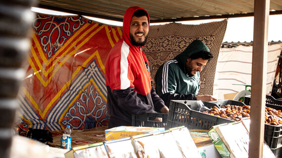 Farj and a colleague sell Tamar dates at his roadside stand in southern Libya.