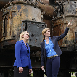 USAID Administrator Samantha Power and U.S. Ambassador to Ukraine Bridget Brink stand in front of a damaged power transformer in Ukraine.