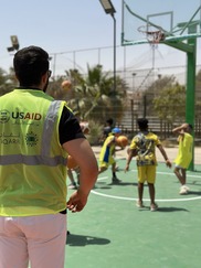 Children play basketball on newly refurbished courts in Zwara.