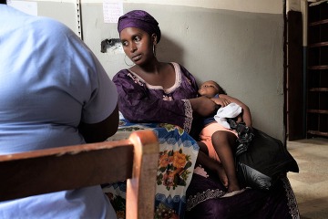 MOTHER AND CHILD DURING PATIENT INTAKE AT ST. ANTHONY’S CLINIC FOR THE POOR IN FREETOWN, SIERRA LEONE.