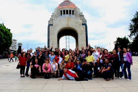 Local journalists from several Mexican states pose in front of the Revolution Monument